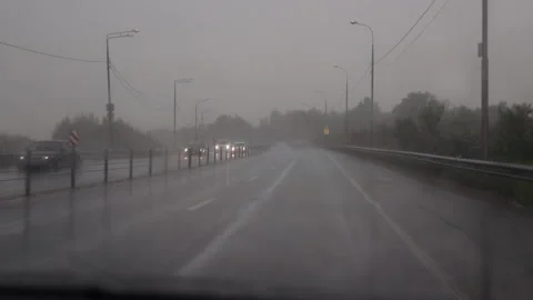 The view through the windshield of a car on a rainy day on the highway  Stock Footage 276821016