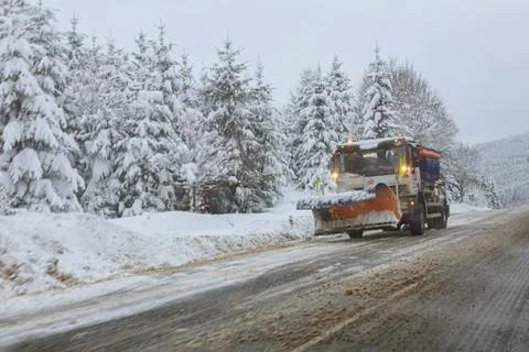 View through the windshield of a car on snow removal equipment. Snow-covered  Stock Photos
