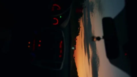 View through windshield of car on traffic on highway at sunset. Vertical video 库存影片 247487620