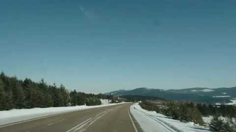 View through the windshield of a car on a truck with logs on the road and a 库存影片 155296567