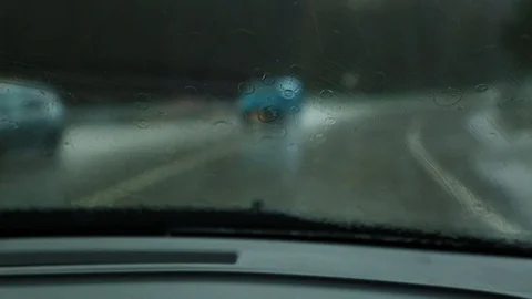 View through the windshield of a driving car in the rain. Stock Footage 101308477