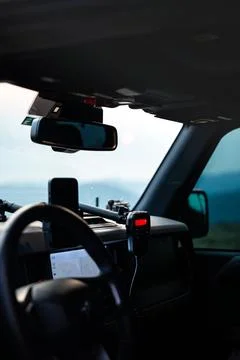 View through windshield of featuring phone, radio, and navigation map Stock Photos