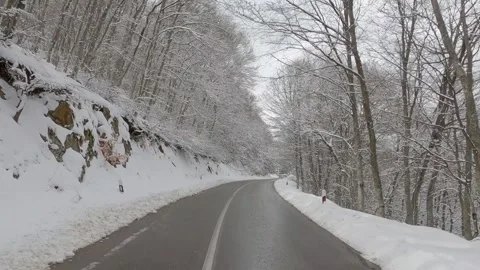 View through the windshield on the highway in winter along which the car is d Stock Footage 325616071
