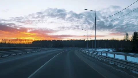 View through the windshield of a moving car on the road with a fence and a Stock Footage 166557397