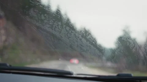 View through the windshield on a rainy road, car wipers are operating. Stock Footage 241990513