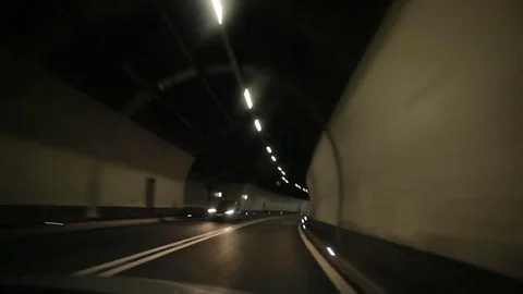 View through the windshield, travel through the mountain tunnel in Switzerland Stock Footage 73377462