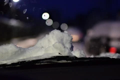 View through windshield on wintry road with snow on the hood Stock Photos