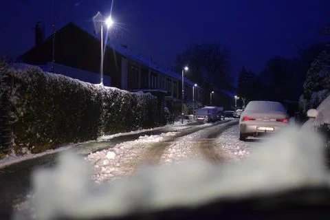 View through windshield on wintry road with snow on the hood Stock Photos