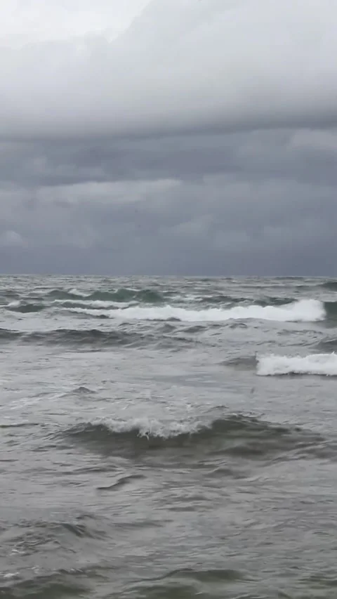 View of tidal ocean waves against a dark sky background Stock Footage 297730968