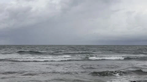 View of tidal ocean waves against a dark sky background Stock Footage 297730969