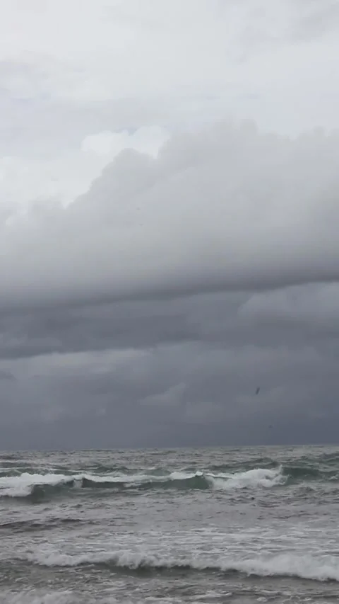 View of tidal ocean waves against a dark sky background Stock Footage 297730976