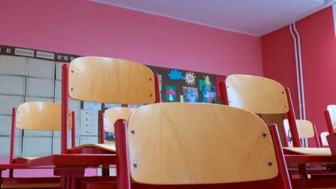 View of a tidy desk in an empty school classroom due to a coronavirus pandemic Stock Photos