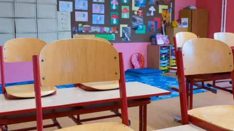 View of a tidy desk in an empty school classroom due to a coronavirus pandemic Stock Photos
