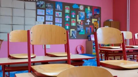 View of a tidy desk in an empty school classroom due to a coronavirus pandemic Stock Photos