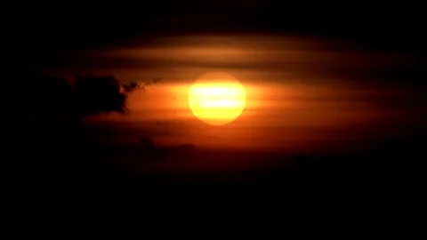 View of timelapse sun silhouette at sunset nightfall beautiful orange sky light Stock Footage 81971588