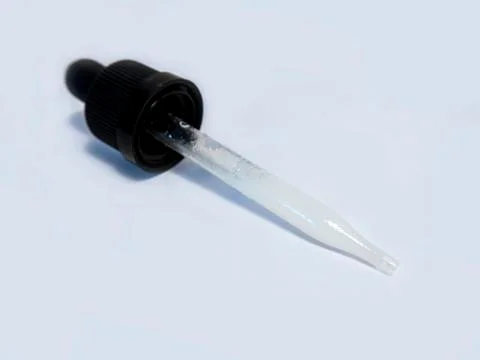 View of a tincture medicinal dropper with a black rubber top against a white  Stock Photos