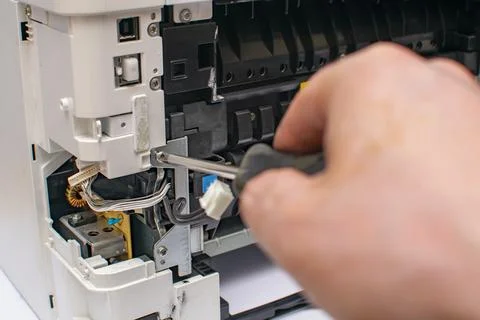 View of the tip of the phillips screwdriver and the printer screw Stock Photos