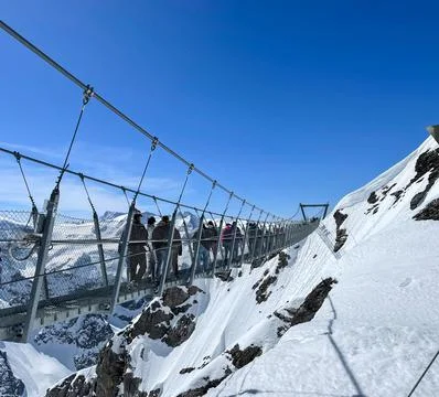 View of TITLIS cliff walkway surrounded by Swiss Alps. Stock Photos