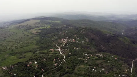 View from the top of an approaching drone shot of the village of Stock Footage 263706946