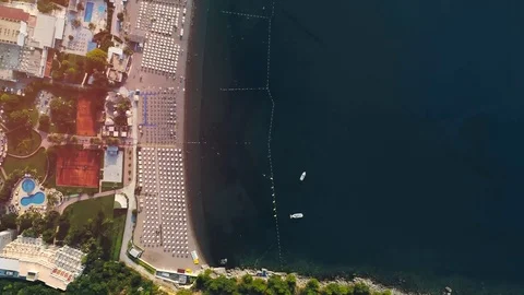 View from the top of the beach with umbrellas in the resort of the European city Stock Footage