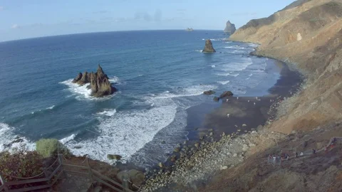 View From Top on Black Sand Beach With Rollings Waves and Rocks in the Sea Video stock 70694499