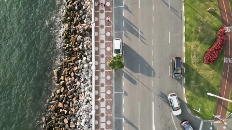 View from top to bottom of waves crashing on the rocks of the seaside avenue. Video stock 246818982