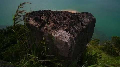 View from the top of the cliff. Two longtail boats are standing on the beach. Stock Footage 80921699