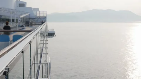 View on the top deck of the giant luxuary cruise ship from the aft area to .. Stock Footage 259789328