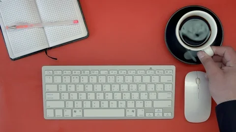 The view from the top. Desk, keyboard, personal organizer. A man typing on the Stock Footage 89348129