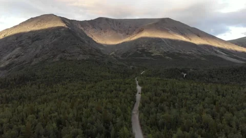 A view from the top of a dirt road along forest leading to the Khibiny mountains Stock Footage 164072853