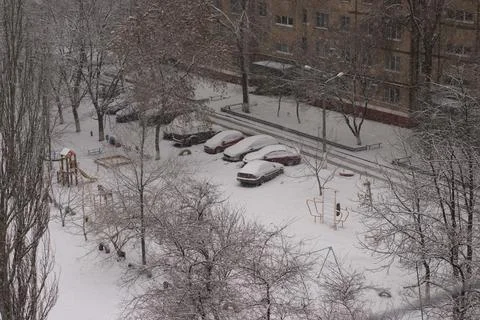 View from the top floor of a snow-covered parking lot. Stock Photos