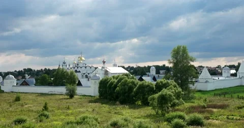 The view from the top of the hill. The ancient monastery is surrounded by fields Video stock 66564648