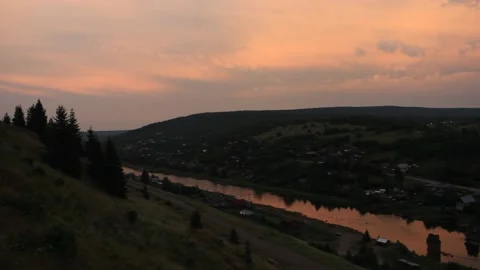 View from the top of the hill to the small river and village at sunset Stock Footage 142512985