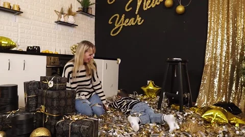 View from the top. Mom throws sparkles, metaphan at her son. A kind family. Stock Footage 165779630