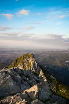 View from the top of Mount Giewont to the cliffs and mountains at sunset Stock Photos