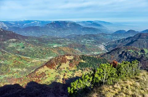 View from the top of a mountain to the distant valley Stock Photos