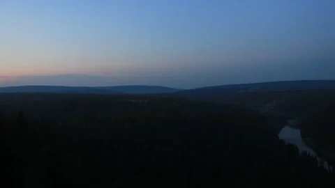The view from the top of the mountain to the forests and the river. Evening. Stock Footage