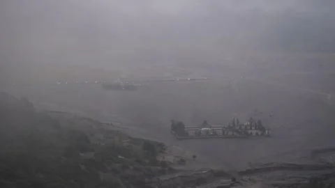 View from the top of the mountain of a misty temple in Bromo Stock Footage 258313836
