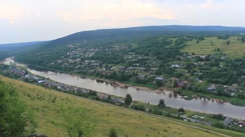 View from the top of the mountain to the river and to the small village Stock Footage 142512990
