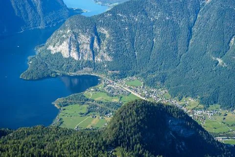 View from the top of the mountain to a small town on a shores of an Alpine la Stock Photos