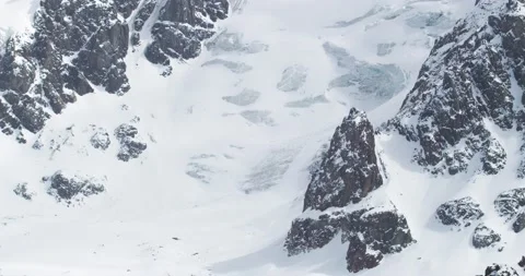 View from top of the mountain to the snowy gorge. Sharp mountain peaks. Glacier. Stock Footage 145111908