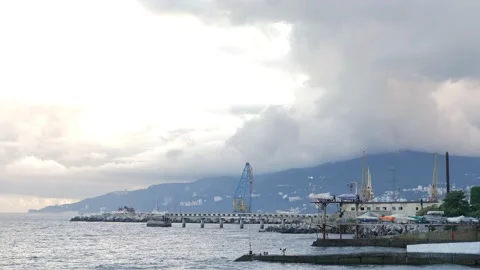 View from the top of the seaside beach to the mountain cliff and the pier. The Stock Footage 222097709