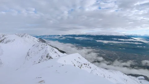 View from the top of snow covered mountains in the alps Stock Footage 100053816