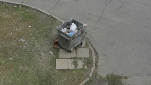 The view from the top of a stuffed garbage bin on the street Stock Footage 86604233