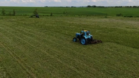 The view from the top. The tractor in the field to mow the grass. panorama Stock Footage 132719336