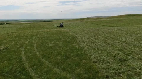 The view from the top. The tractor in the field to mow the grass. panorama down Stock Footage 132719398