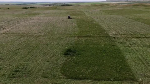 View from the top. The tractor in the field to mow the grass. the overall plan Stock Footage 132719430