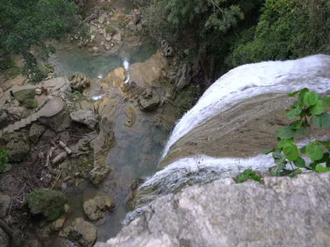 View from the top of waterfall down to lake in a middle tropical jungle Stock Footage 71422734