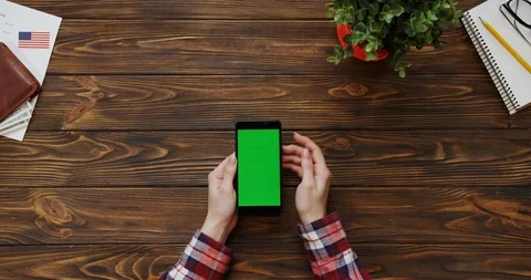 View from the top on the woman's hands scrolling and taping on the black Stock Footage 91721177