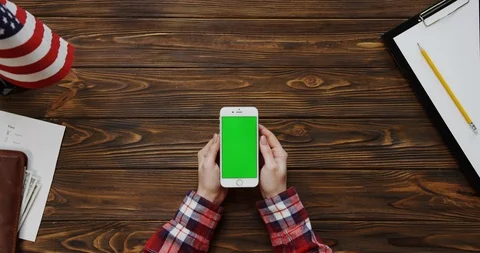 View from the top on the woman's hands scrolling and taping on the white Stock Footage 91723168